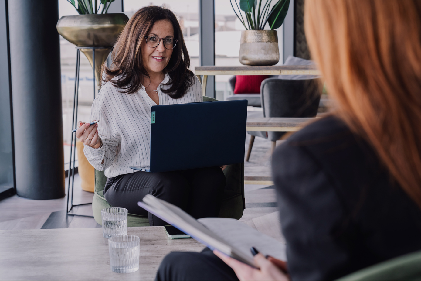 Woman with a laptop talking to a client